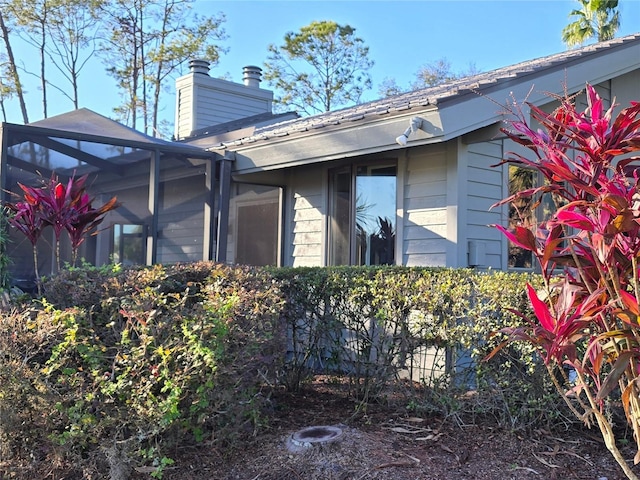 5474 Kemkerry Rd, Wesley Chapel, FL 33543 - view of side of home with a chimney and a lanai