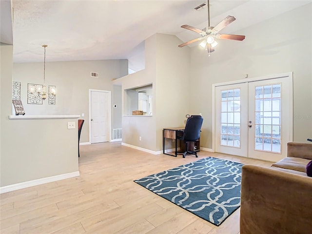 living room featuring french doors, high vaulted ceiling, wood-type flooring, and ceiling fan with notable chandelier