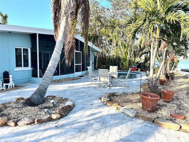 view of patio featuring a sunroom