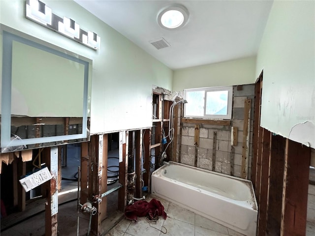 bathroom featuring tile patterned floors and a bathtub