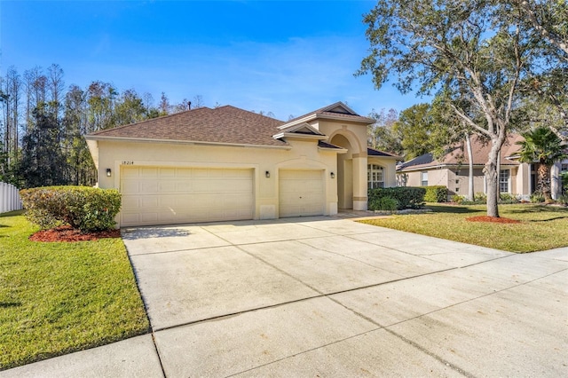 mediterranean / spanish-style home featuring a front lawn and a garage