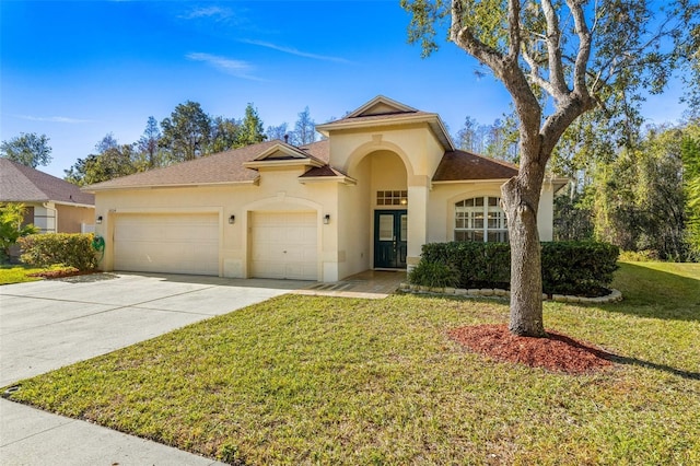 mediterranean / spanish-style home with a front lawn and a garage