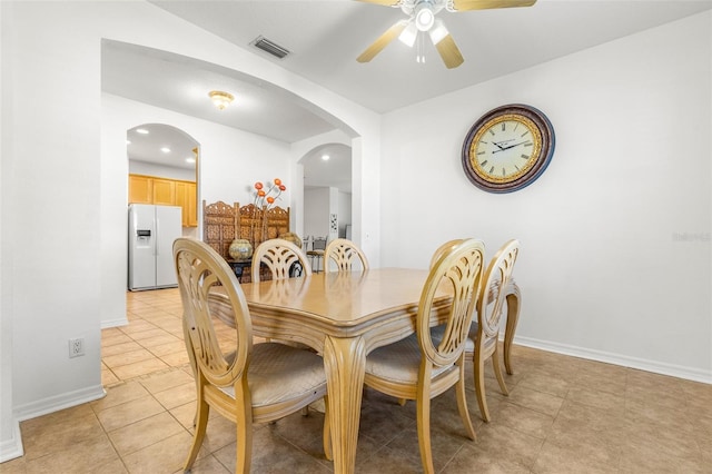 dining space featuring ceiling fan and light tile patterned floors