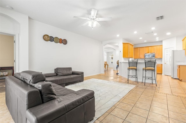 living room with ceiling fan and light tile patterned flooring