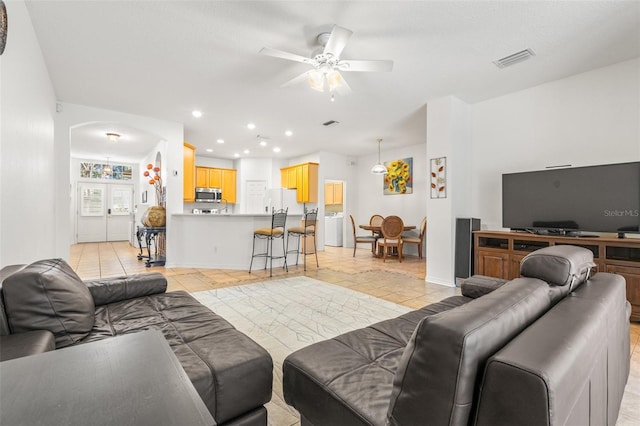 tiled living room with ceiling fan