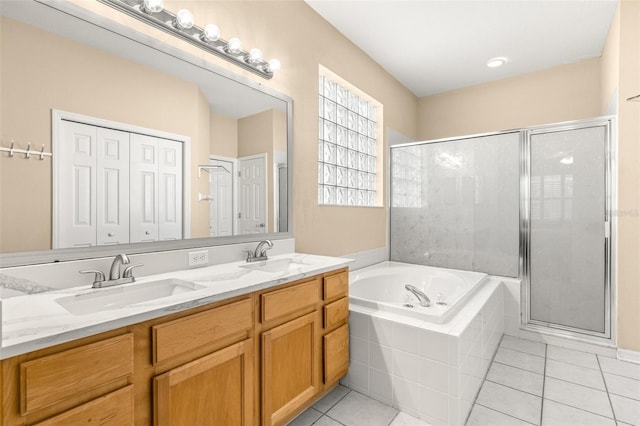 bathroom with tile patterned flooring, vanity, and independent shower and bath