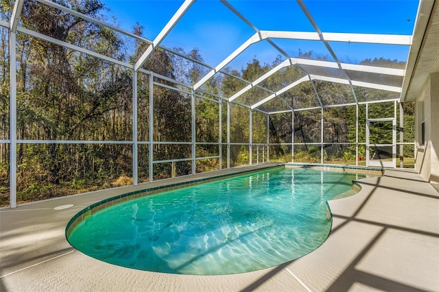 view of pool with a lanai and a patio area