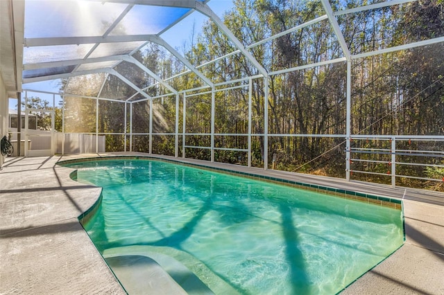 view of swimming pool featuring a lanai and a patio