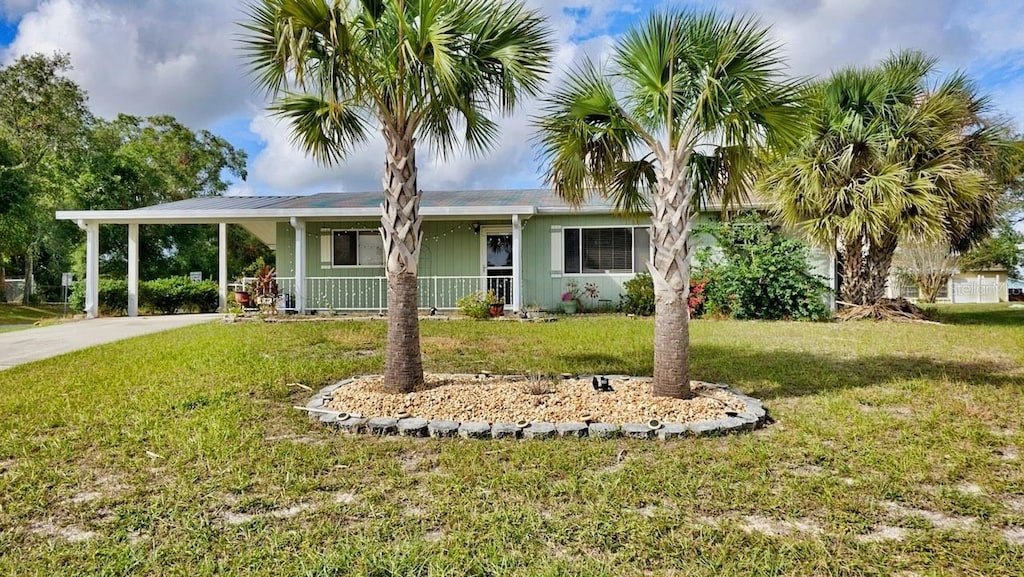 view of front of property with a carport, covered porch, and a front yard