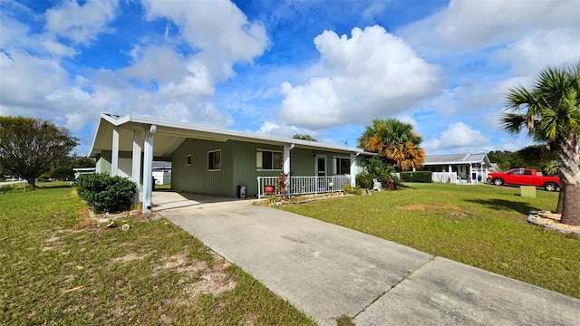 ranch-style home featuring a carport, a porch, and a front lawn