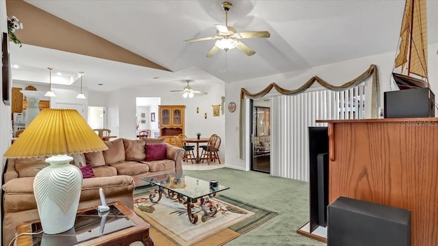 living room featuring ceiling fan, lofted ceiling, and carpet