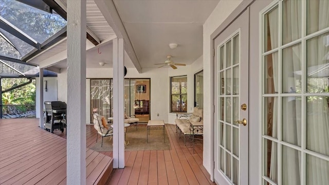 unfurnished sunroom with ceiling fan