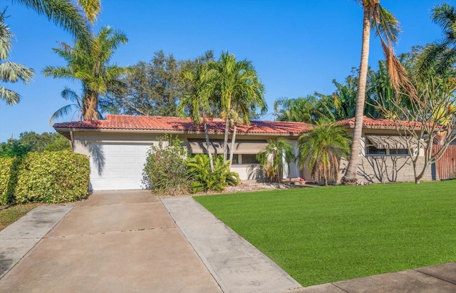 view of front of house featuring a front lawn and a garage