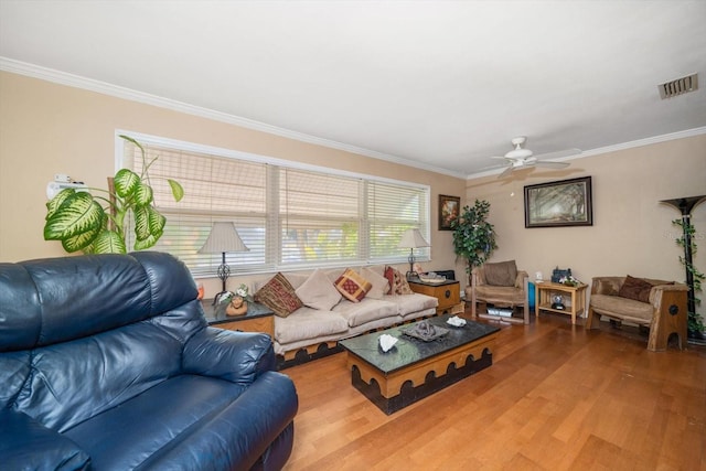 living room with ceiling fan, ornamental molding, and hardwood / wood-style floors