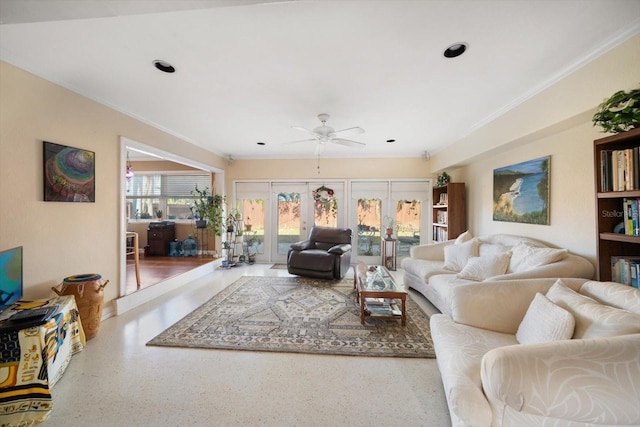 living room with ceiling fan, french doors, and ornamental molding