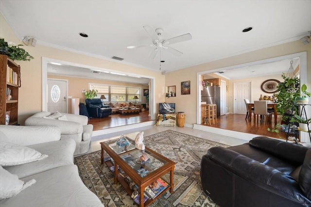 living room with ceiling fan, crown molding, and dark hardwood / wood-style floors