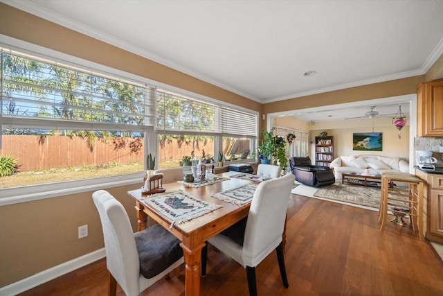 dining room with a healthy amount of sunlight, crown molding, and wood-type flooring