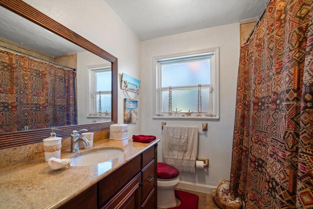 bathroom with toilet and vanity