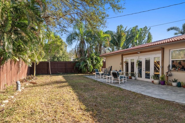 view of yard with a patio area and french doors