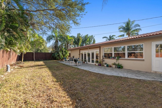 view of yard featuring french doors and a patio area