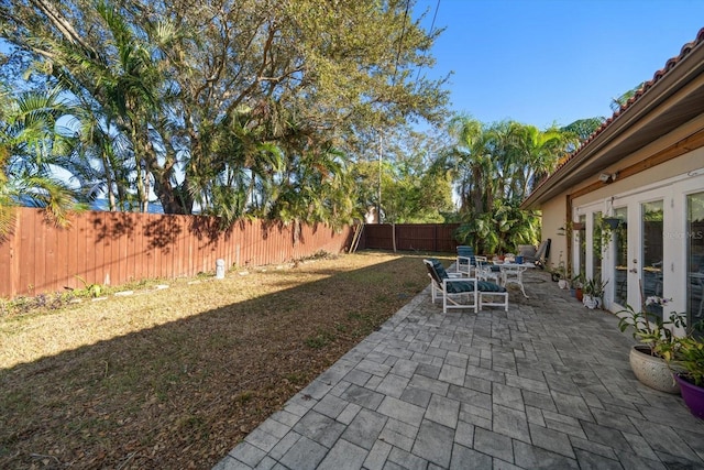 view of yard with french doors and a patio