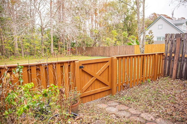 view of gate with a fenced backyard