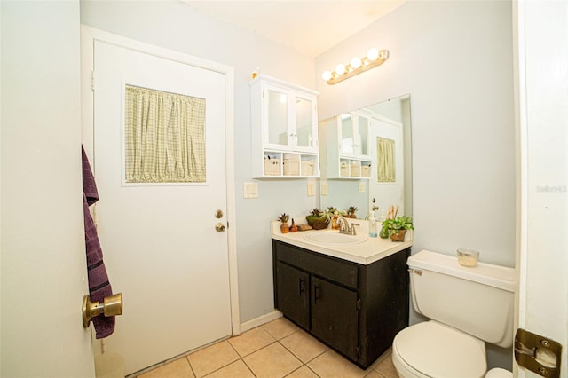 bathroom featuring toilet, vanity, and tile patterned flooring