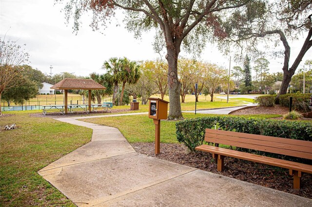 view of home's community featuring a gazebo, a lawn, and fence