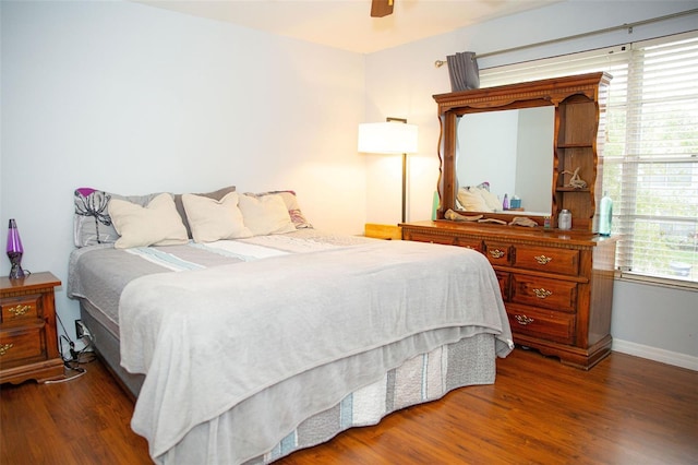 bedroom featuring ceiling fan, baseboards, and wood finished floors