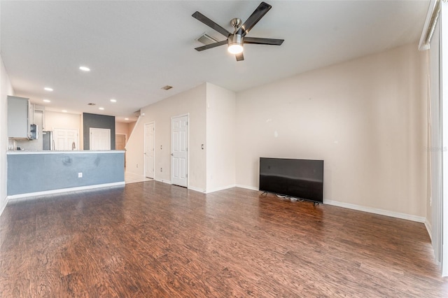 unfurnished living room featuring dark hardwood / wood-style floors and ceiling fan