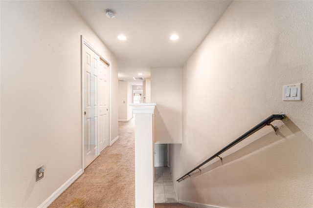 hallway with light colored carpet