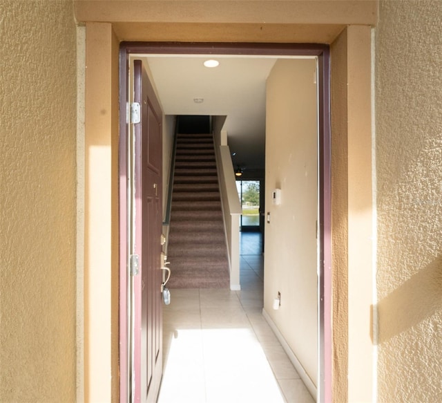 corridor featuring light tile patterned floors