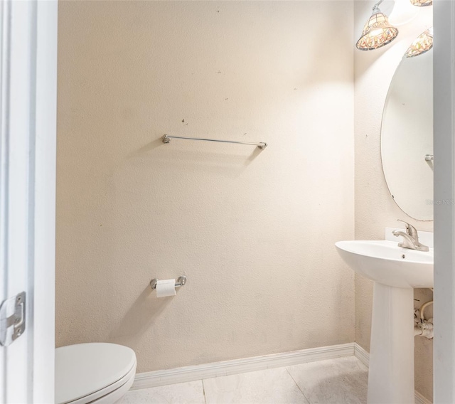 bathroom with tile patterned flooring, toilet, and sink