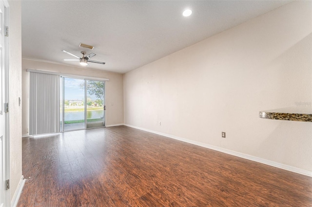 unfurnished room featuring ceiling fan and dark hardwood / wood-style floors