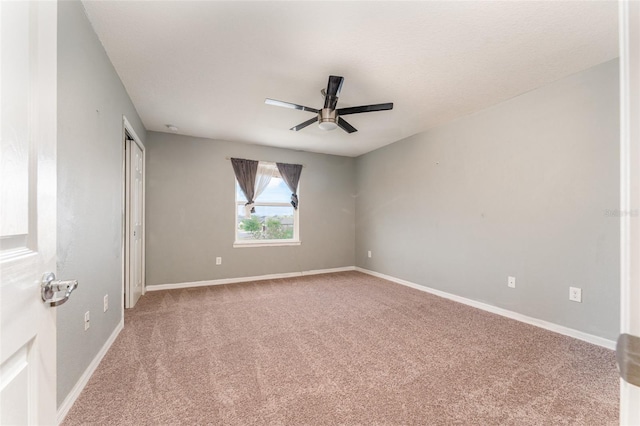 spare room with ceiling fan and carpet floors