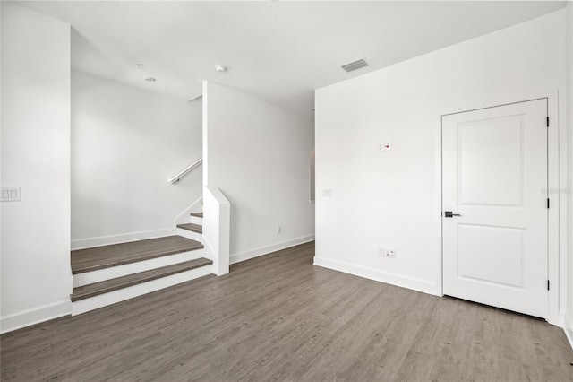 spare room featuring wood-type flooring