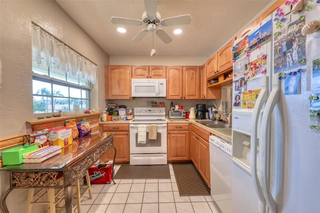 kitchen featuring ceiling fan, sink, light tile patterned floors, and white appliances