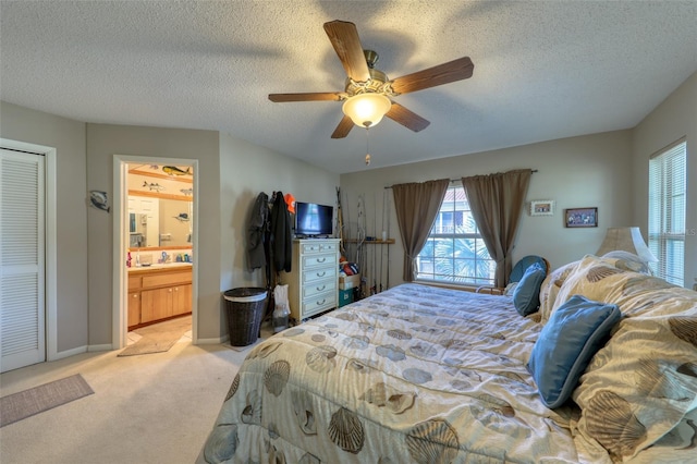 carpeted bedroom featuring a textured ceiling and ceiling fan