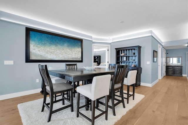 dining space with light hardwood / wood-style floors