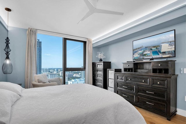 bedroom with light hardwood / wood-style floors and ceiling fan