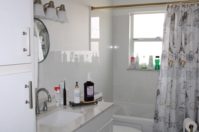 full bathroom with vanity, toilet, tile walls, and shower / tub combo with curtain