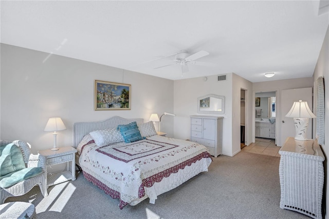 carpeted bedroom featuring ensuite bathroom and ceiling fan