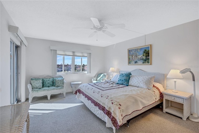 bedroom featuring ceiling fan, carpet, and a textured ceiling