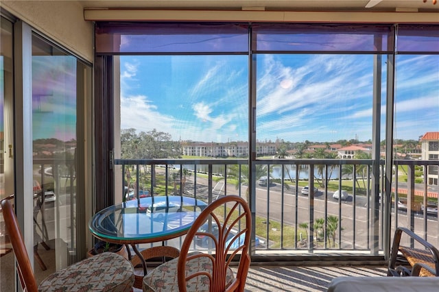 sunroom / solarium with a water view