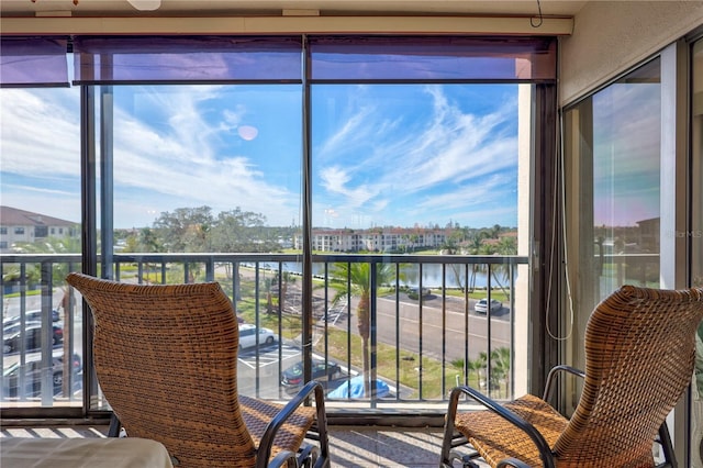 sunroom with a water view and a healthy amount of sunlight