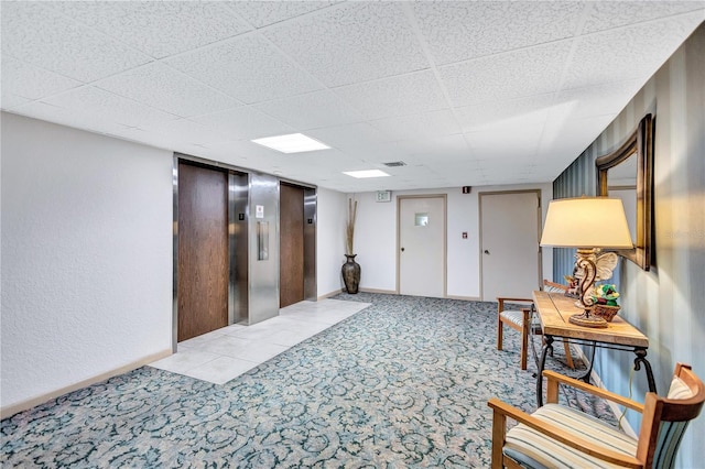 interior space featuring light colored carpet and elevator