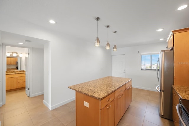 8701 Blind Pass Rd Unit 306B, St Pete Beach, FL 33706 - kitchen with freestanding refrigerator, a center island, light stone countertops, hanging light fixtures, and recessed lighting