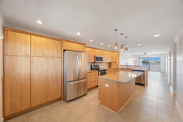 kitchen featuring sink, hanging light fixtures, kitchen peninsula, light brown cabinetry, and appliances with stainless steel finishes