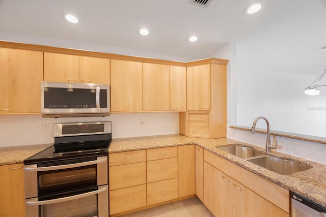8701 Blind Pass Rd Unit 306B, St Pete Beach, FL 33706 - kitchen featuring stainless steel appliances, light brown cabinets, light stone countertops, and recessed lighting