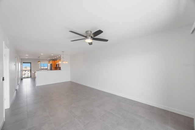 8701 Blind Pass Rd Unit 306B, St Pete Beach, FL 33706 - unfurnished living room featuring a ceiling fan, recessed lighting, a chandelier, and tile patterned floors